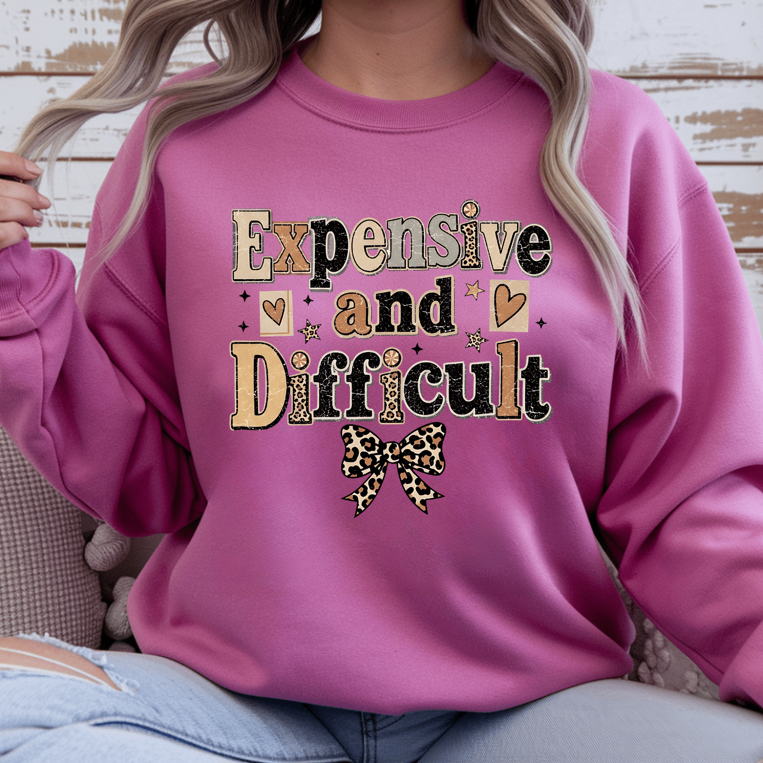 Comfortable women's crewneck sweater with Expensive and Difficult graphic print, leopard bow accent, and stylish everyday fashion look.