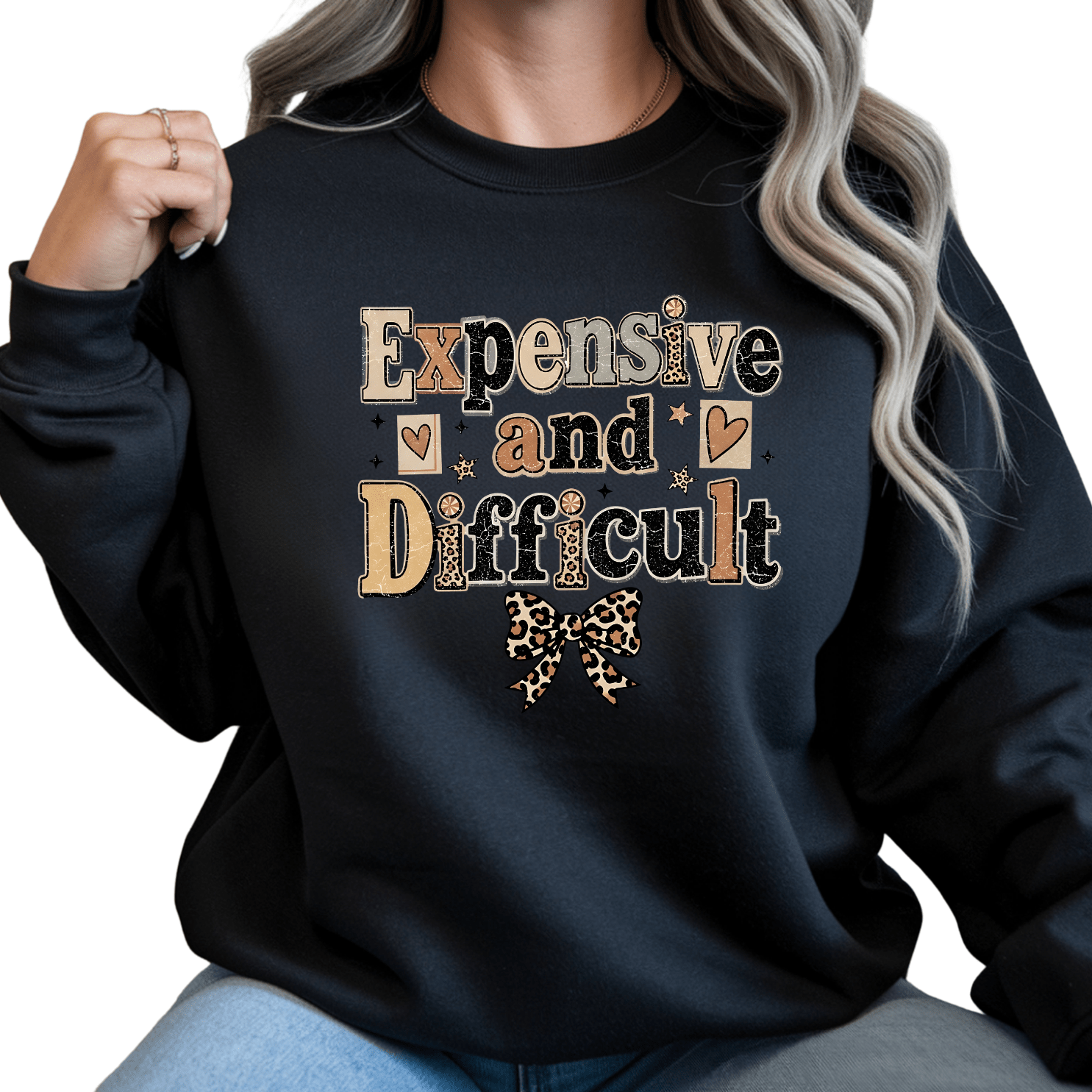 Black women's crewneck sweatshirt featuring bold Expensive and Difficult graphic artwork with leopard bow and modern boutique fashion appeal.