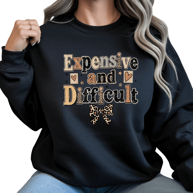 Black women's crewneck sweatshirt featuring bold Expensive and Difficult graphic artwork with leopard bow and modern boutique fashion appeal.