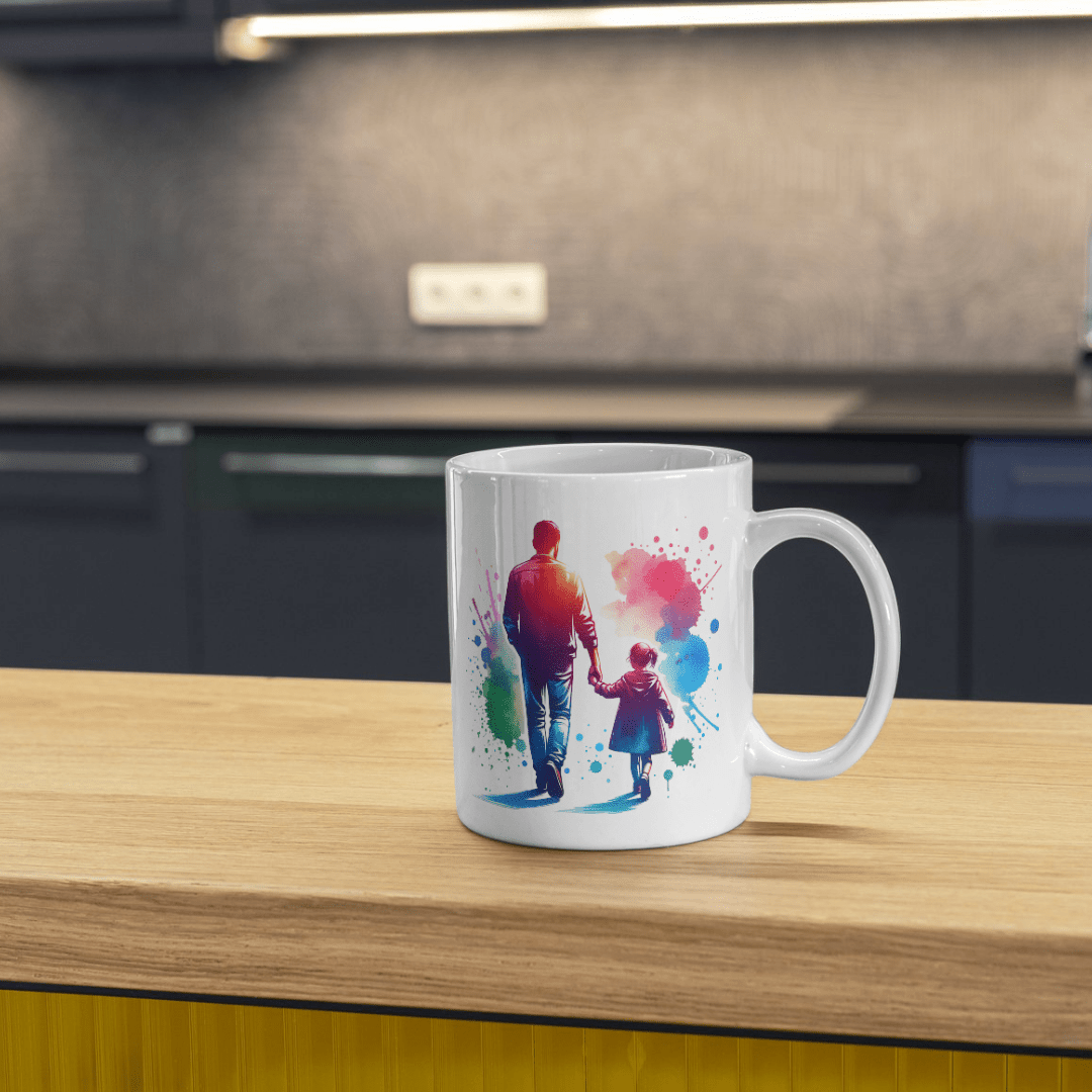 White ceramic father and daughter coffee mug with colorful watercolor splash artwork in modern kitchen setting