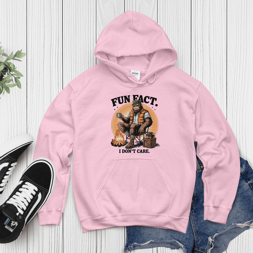 Pink hoodie with humorous camping design and bold “Fun Fact I Don’t Care” text for casual streetwear style