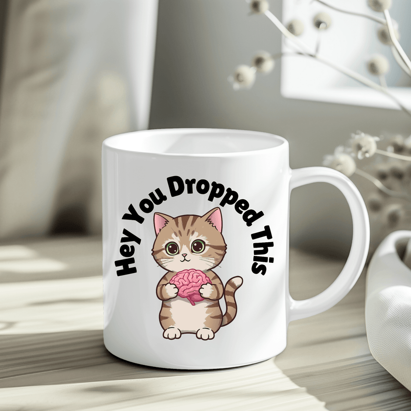 Funny cat illustration mug displayed in crinkle paper gift packaging.