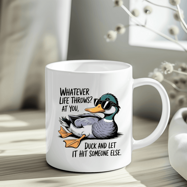 White ceramic mug with a cartoon duck wearing sunglasses and a funny quote