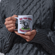 Dark humor novelty mug showing a cute Grim Reaper character with a drink and a cheeky offensive phrase.