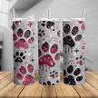 20 oz skinny tumbler featuring pink and black glitter paw prints on a stylish background with stainless steel straw for dog lovers and pet moms.