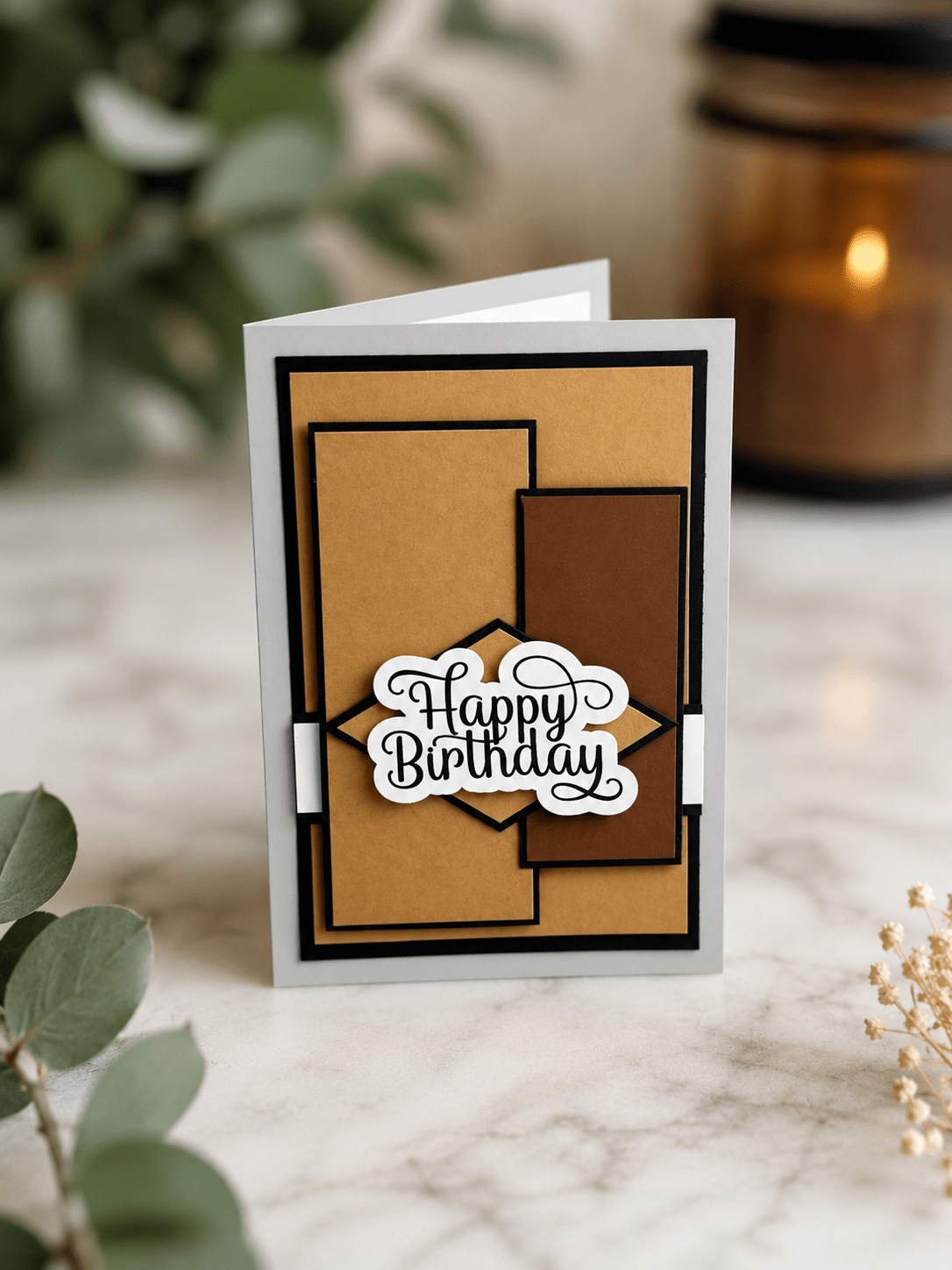 Premium neutral birthday greeting card displayed in a modern setting with dimensional geometric details and a bold black script birthday message.