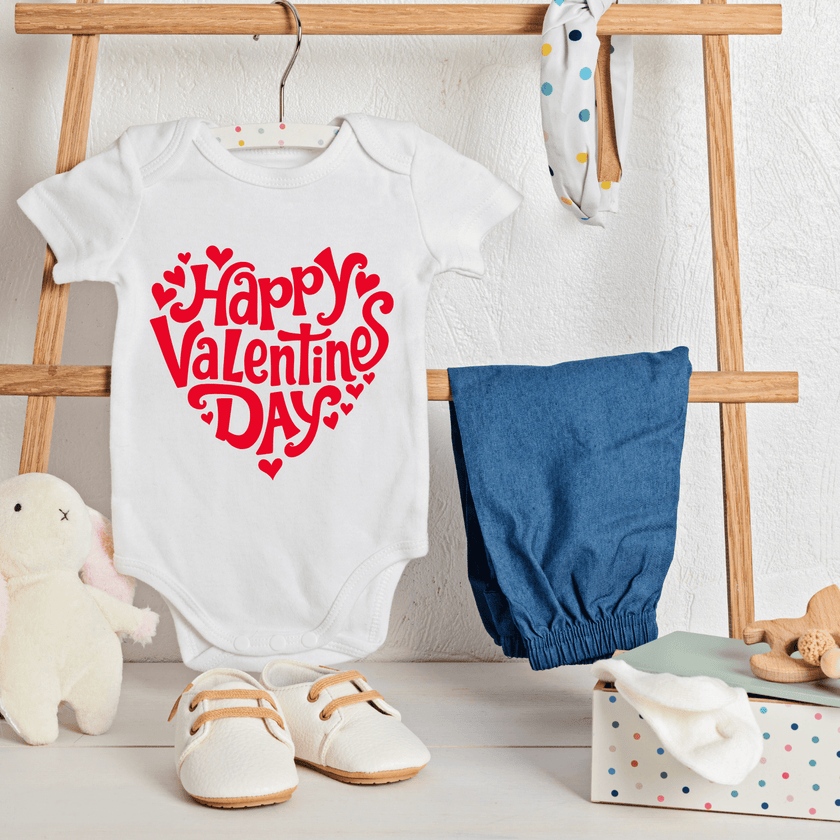 Baby Valentine onesie hanging on rack with nursery decor