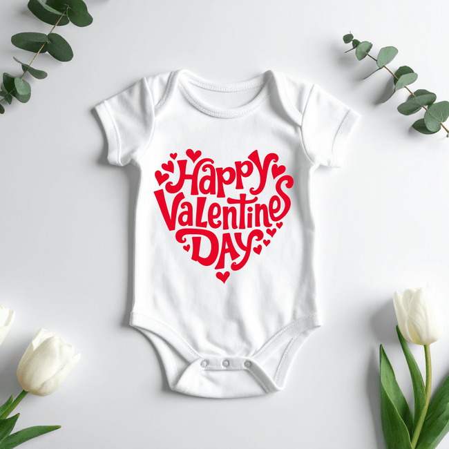 White Happy Valentine’s Day baby onesie with red heart design laid flat