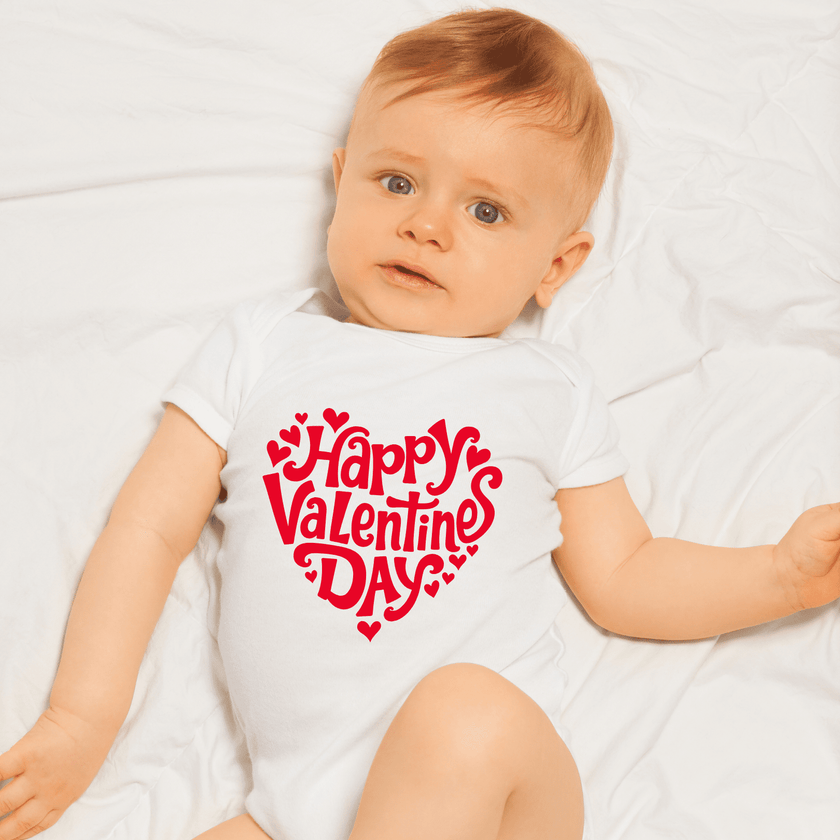 Infant wearing Happy Valentine’s Day onesie during photoshoot
