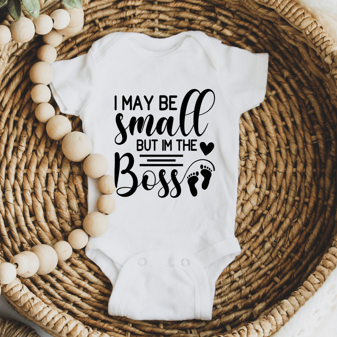 Soft white newborn onesie featuring humorous little boss design for baby gifts and everyday wear