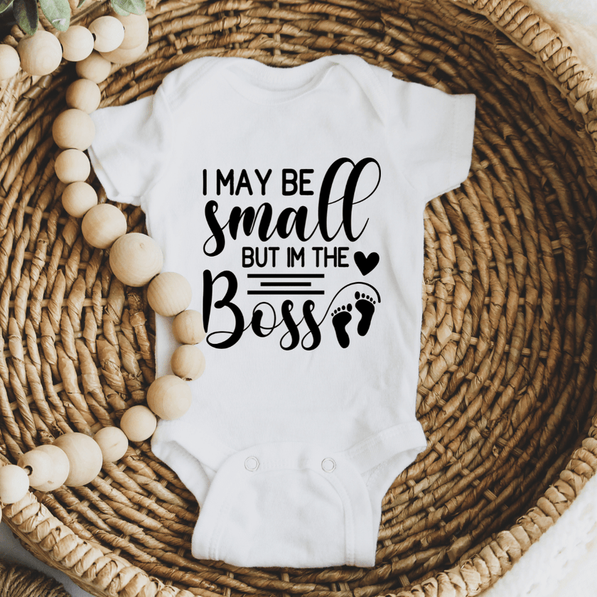 Soft white newborn onesie featuring humorous little boss design for baby gifts and everyday wear