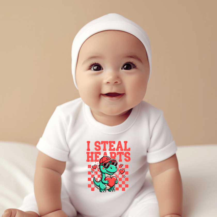 Newborn wearing dinosaur baby onesie for Valentine’s Day
