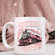 Funny pink train coffee mug featuring humorous text and floral accents on soft pink lifestyle background