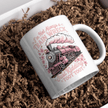White ceramic mug with pink train illustration and funny train wreck quote design on crinkle paper background