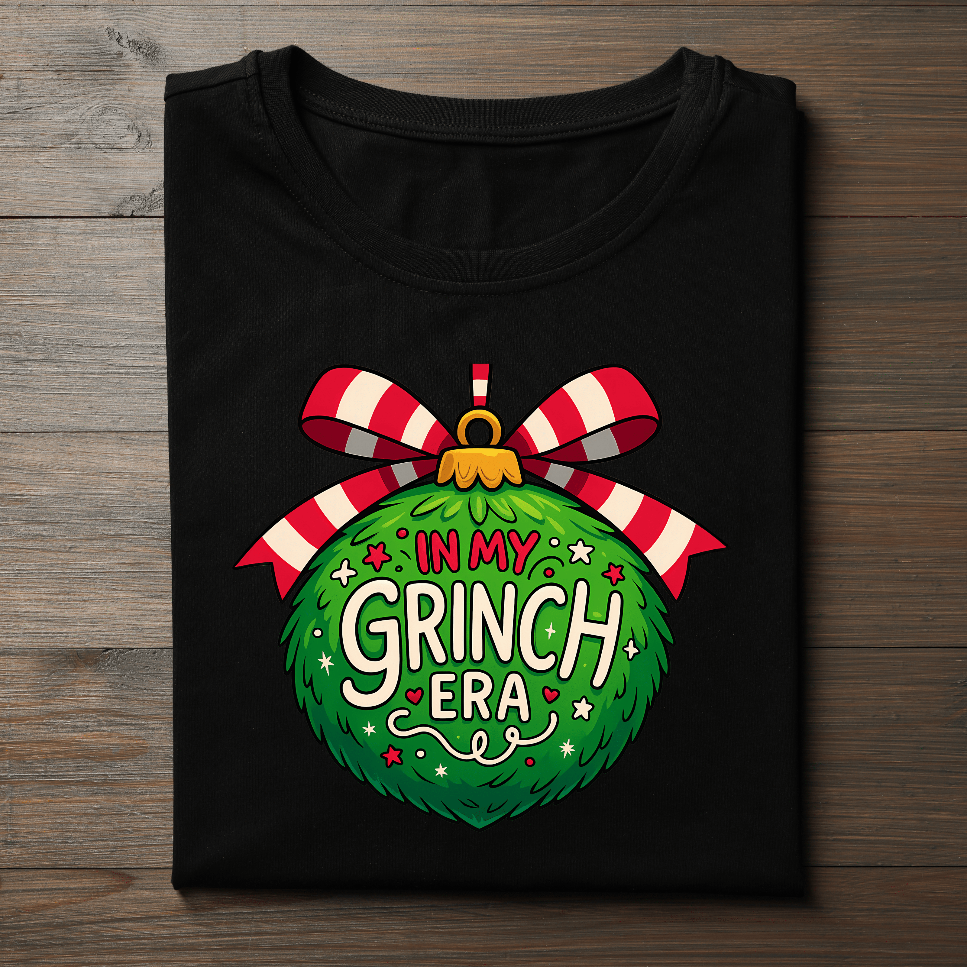 Trendy Christmas T-shirt with In My Grinch Era lettering and festive ornament. Funny and cute holiday graphic tee.
