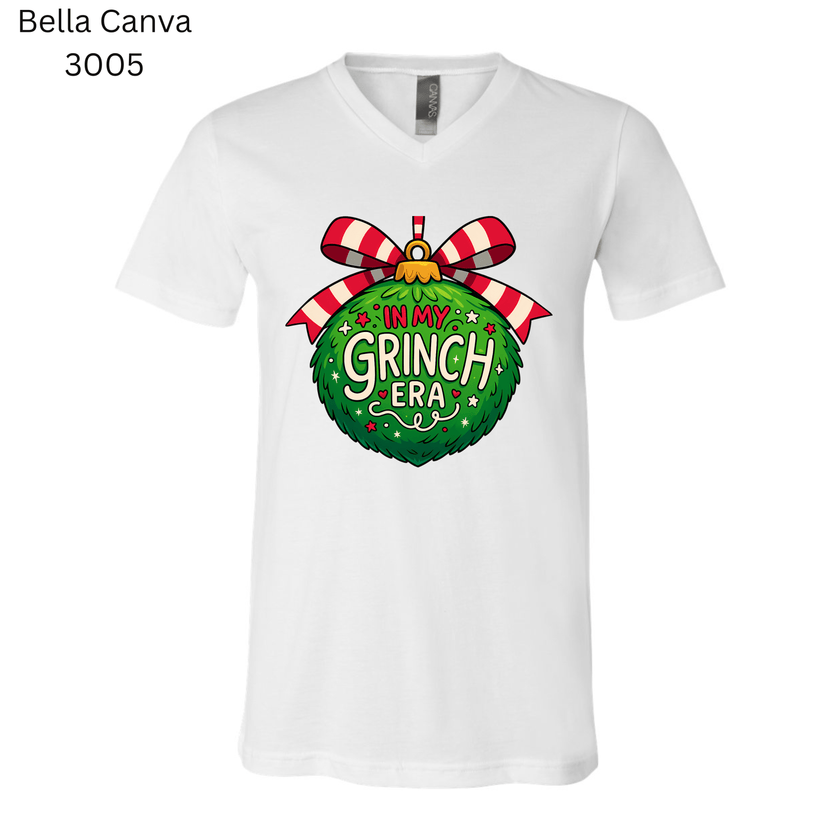 Holiday T-shirt that reads ‘In My Grinch Era’ with a colorful Christmas ornament. Perfect funny tee for cozy winter outfits.