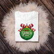 Festive In My Grinch Era graphic T-shirt featuring green ornament and red bow. Funny Christmas shirt for the holiday season.