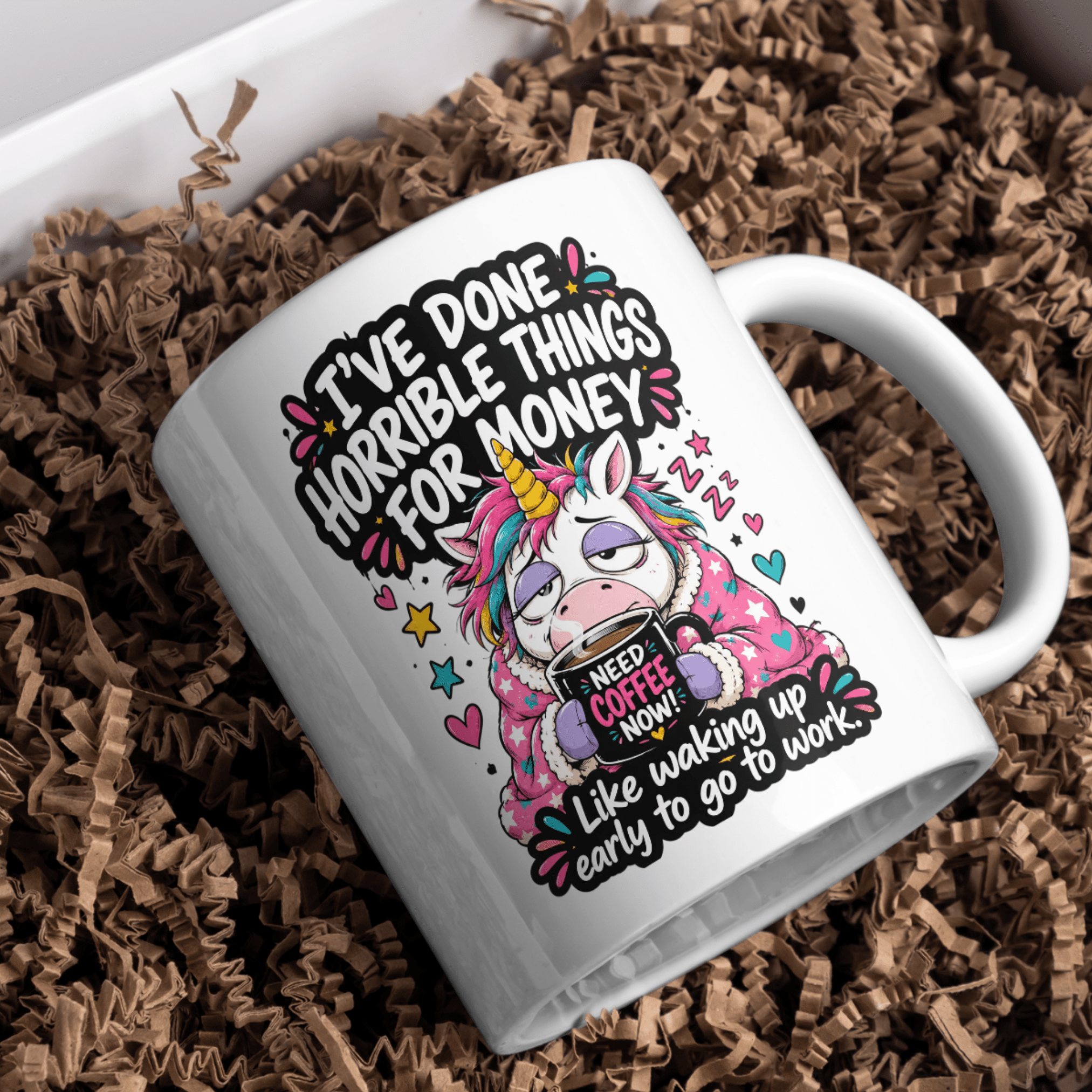 White ceramic funny unicorn coffee mug featuring the quote I've Done Horrible Things for Money Like Waking Up Early to Go to Work on a marble kitchen countertop.