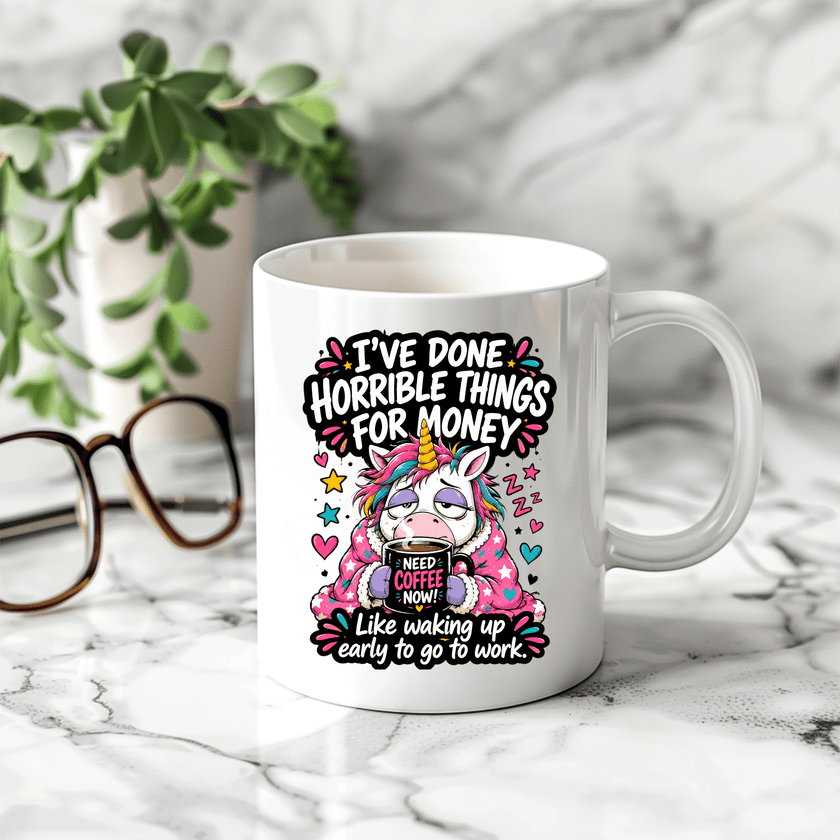 Funny novelty coffee mug with sleepy unicorn artwork and sarcastic work saying displayed in a bright modern kitchen setting.