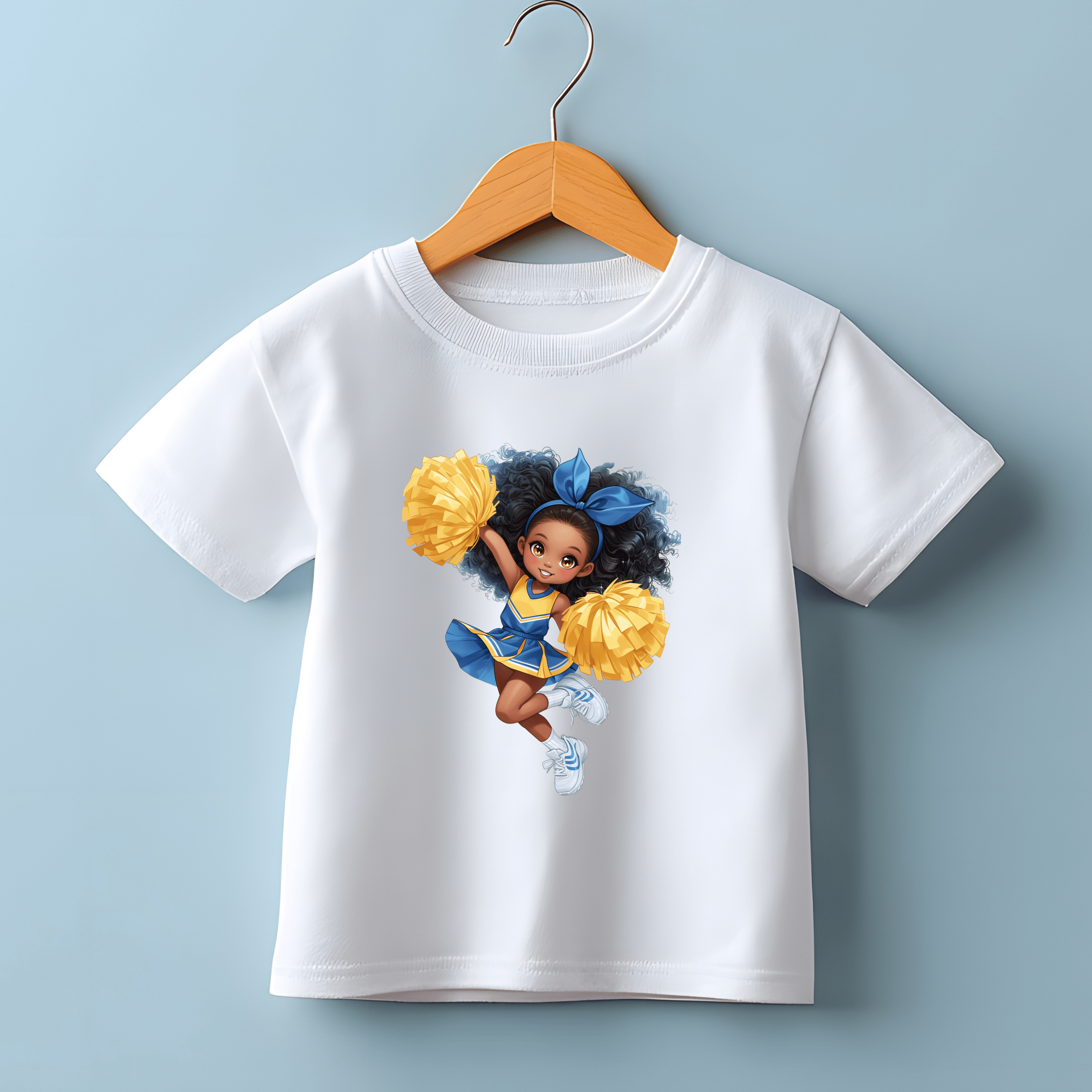 Kids white cheerleader t-shirt hanging on wooden hanger with bright graphic print.