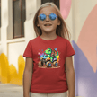 Red youth girls T shirt with a playful dino truck print, sunglasses styling, and boutique kids apparel feel.