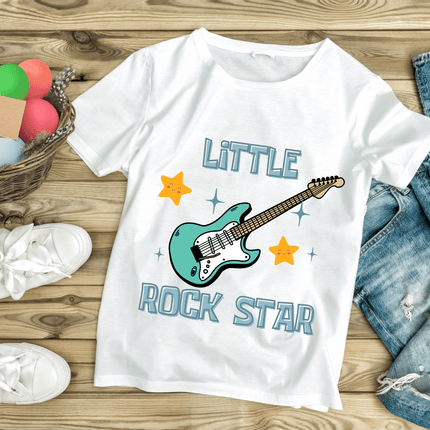 White t-shirt with 'Little Rock Star' design on a wooden surface with casual items.