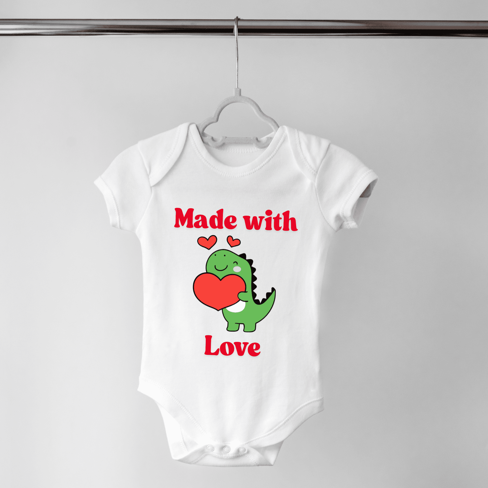 Valentine’s Day baby onesie with green dinosaur graphic