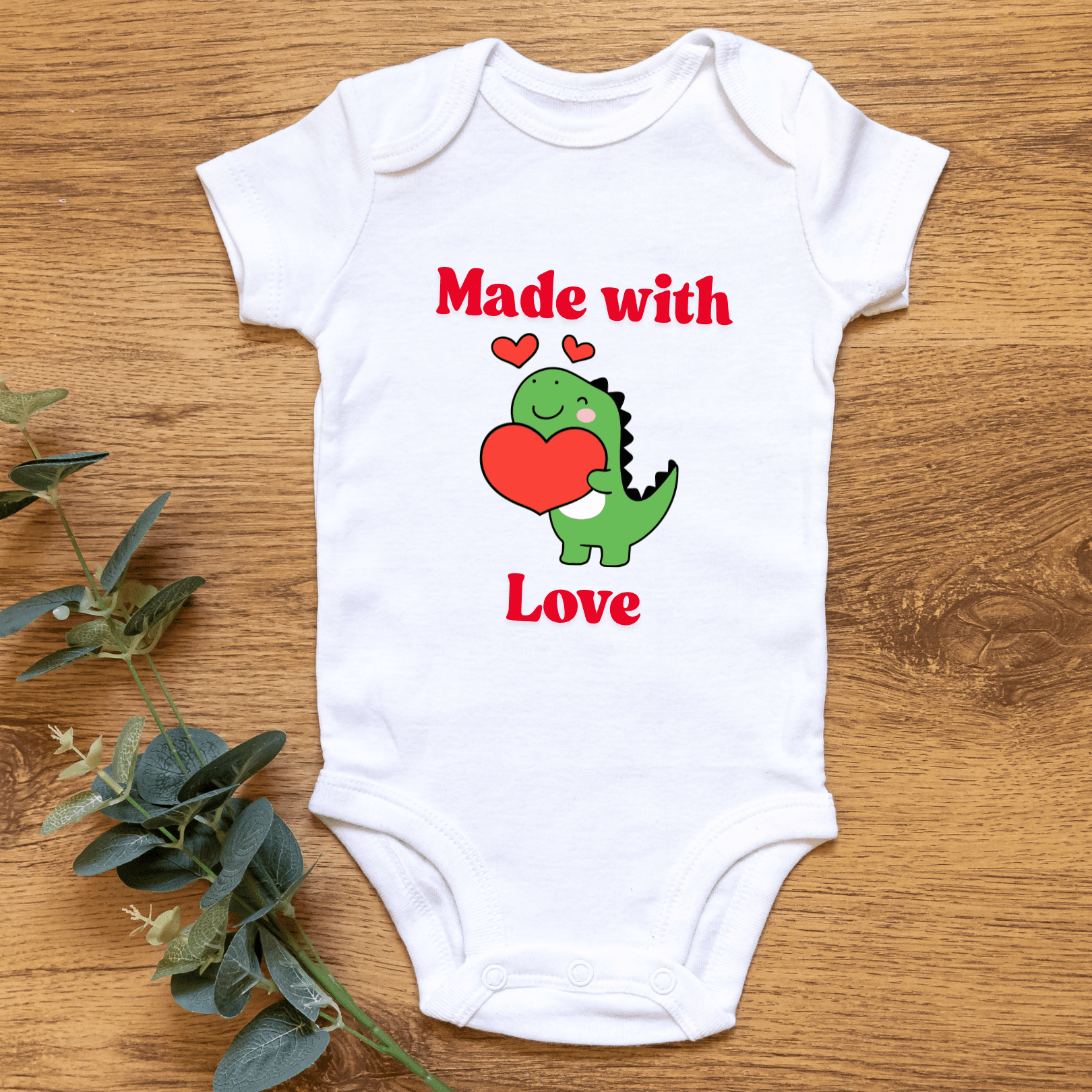 Newborn wearing Made with Love Valentine dinosaur onesie