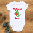 Newborn wearing Made with Love Valentine dinosaur onesie