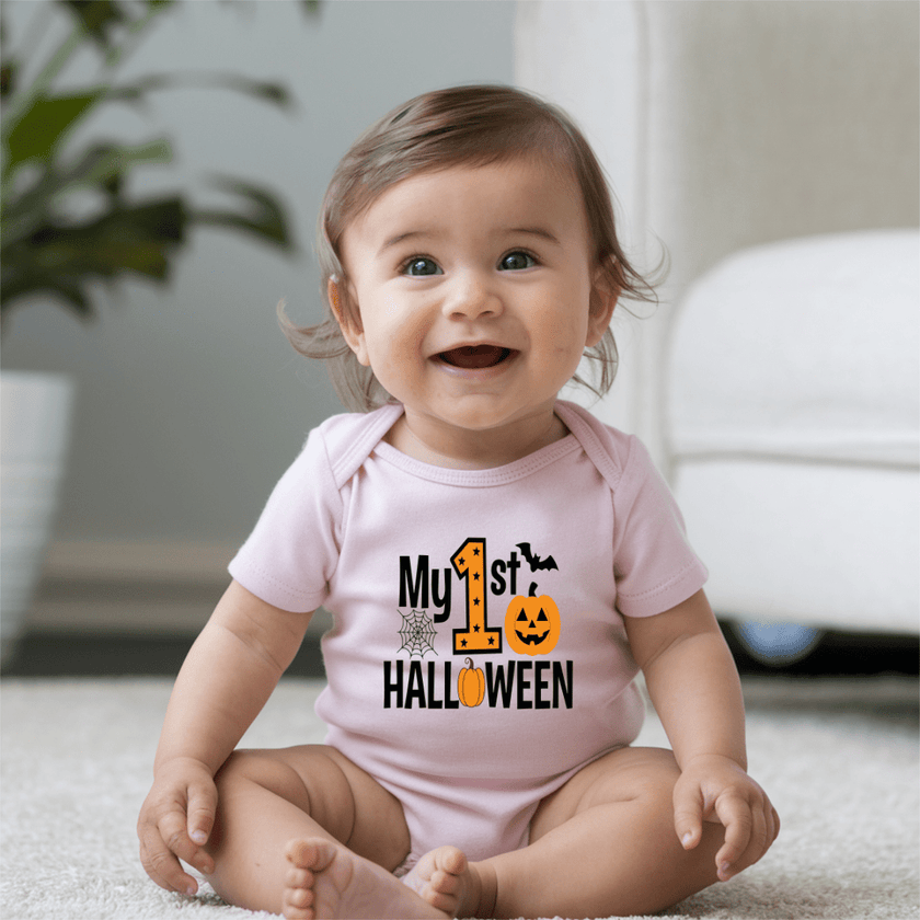 Happy baby wearing a light pink My First Halloween bodysuit with black and orange Halloween graphic.
