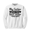 Close-up of black script “HAS THE Best Sister” section with heart cutouts on pink sweatshirt