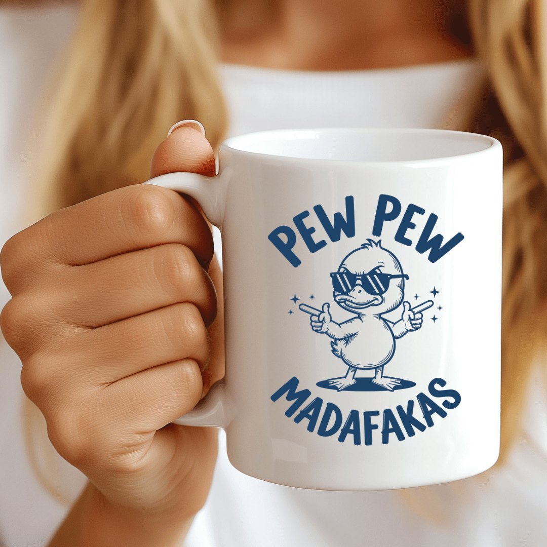 White ceramic coffee mug featuring funny duck character wearing sunglasses with Pew Pew Madafakas novelty graphic design.