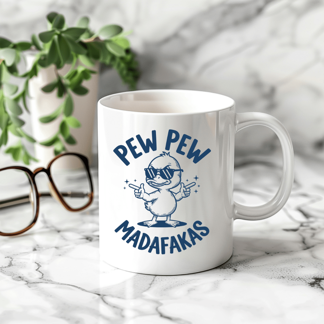 Humorous white coffee mug with sarcastic duck illustration and funny quote displayed on marble countertop setting.