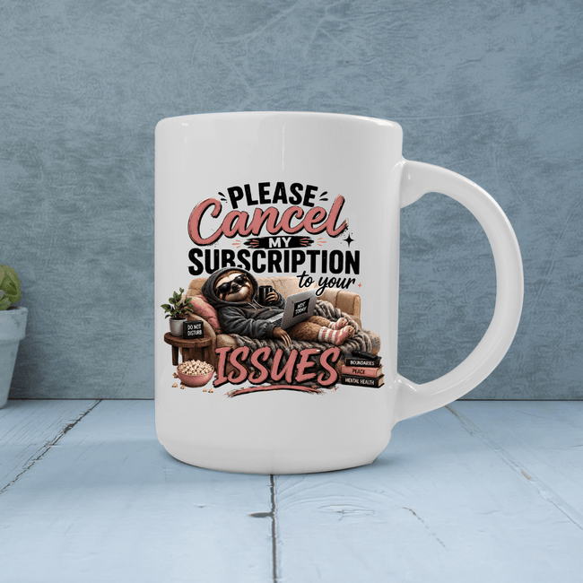 White sarcastic coffee mug featuring a lounging sloth, cozy blanket, laptop and bold Please Cancel My Subscription to Your Issues artwork.