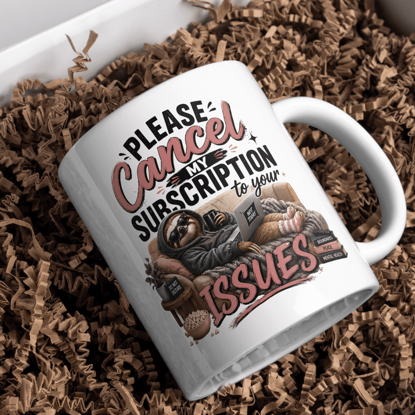 White sarcastic coffee mug featuring a lounging sloth, cozy blanket, laptop and bold Please Cancel My Subscription to Your Issues artwork.