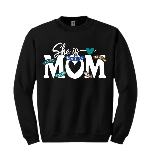 Black crewneck sweater with bold She Is Mom graphic and colorful affirmation words