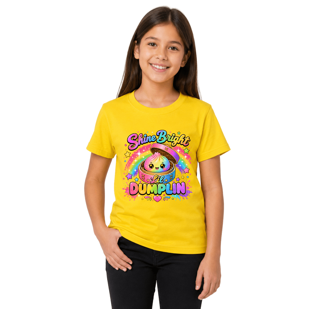 Yellow youth graphic T shirt worn by a girl with a bright rainbow dumpling design and Shine Bright Lil Dumplin lettering.