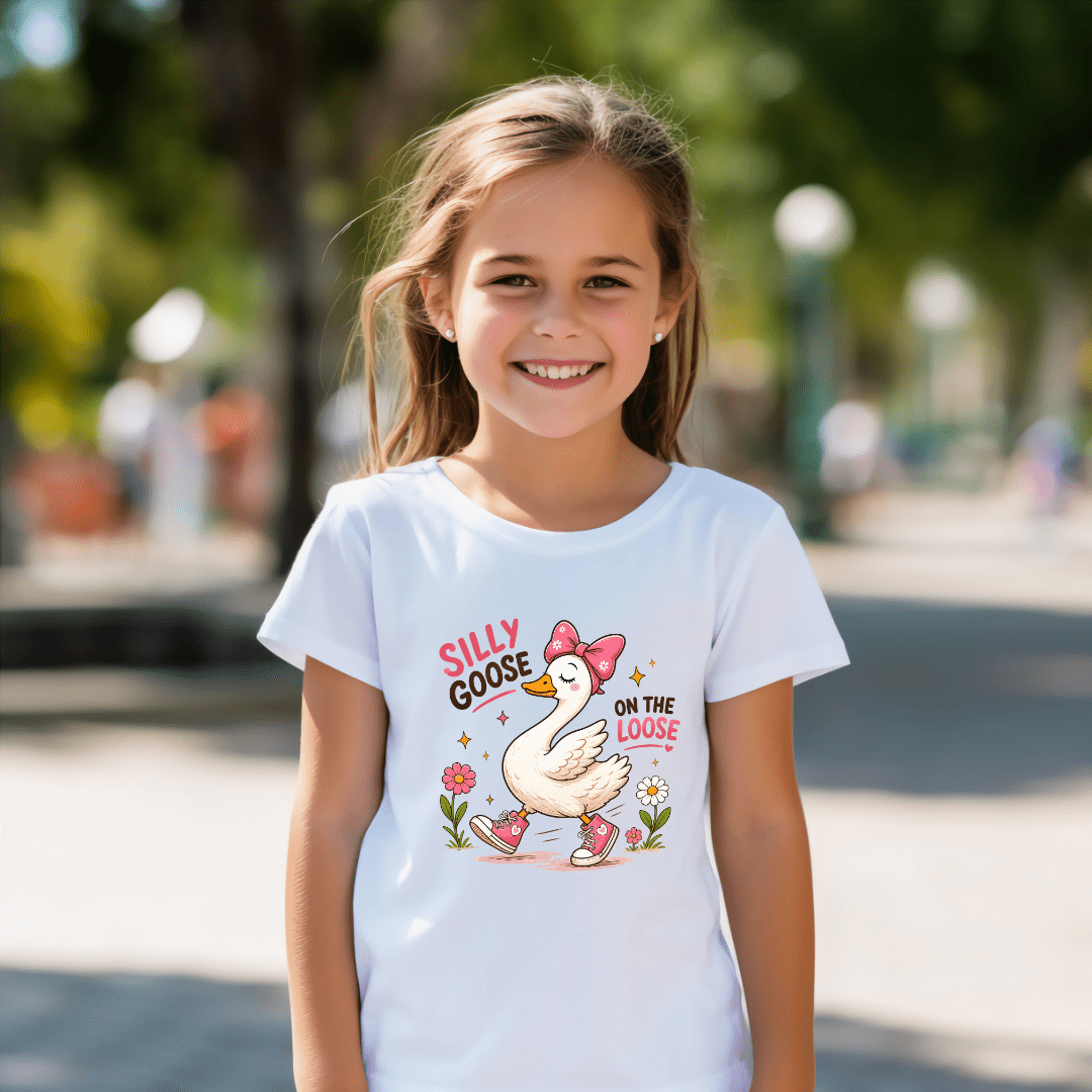White kids t shirt with a playful goose design, pink shoes, floral accents, and a fun silly goose quote.