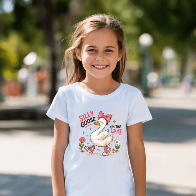 White kids t shirt with a playful goose design, pink shoes, floral accents, and a fun silly goose quote.
