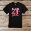 Close-up of black graphic tee with vibrant pink glittery skeleton hand OFF switch and playful hearts