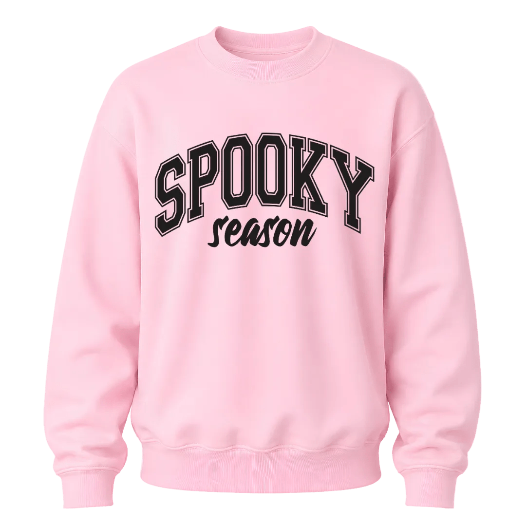 Light pink Spooky Season crewneck sweatshirt featuring black collegiate Halloween lettering for women and fall outfits
