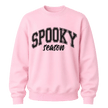 Light pink Spooky Season crewneck sweatshirt featuring black collegiate Halloween lettering for women and fall outfits