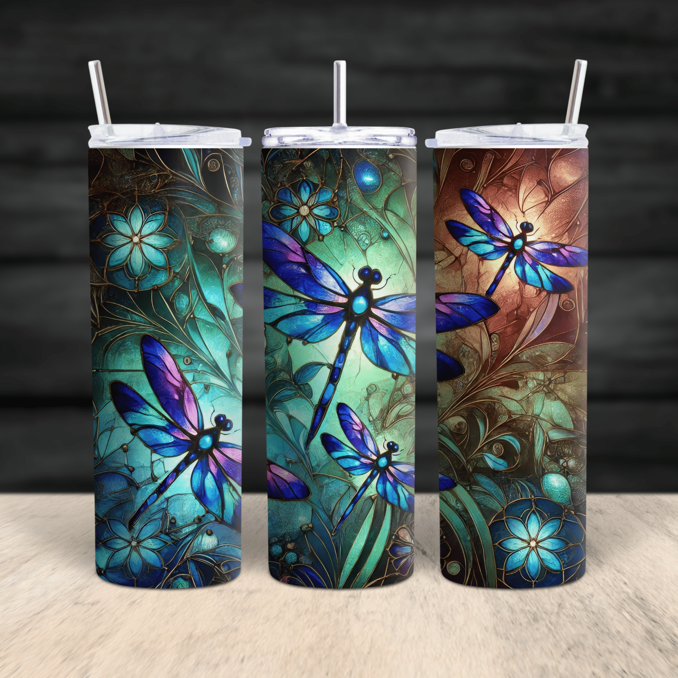 A vibrant stainless steel tumbler featuring stained-glass style dragonflies in blue, teal, and purple tones.