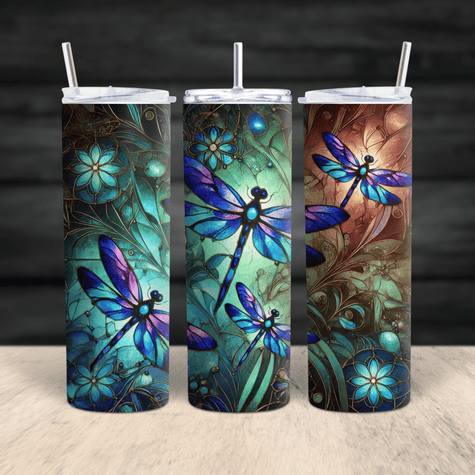 A vibrant stainless steel tumbler featuring stained-glass style dragonflies in blue, teal, and purple tones with floral detailing and a full 360° wrap design.