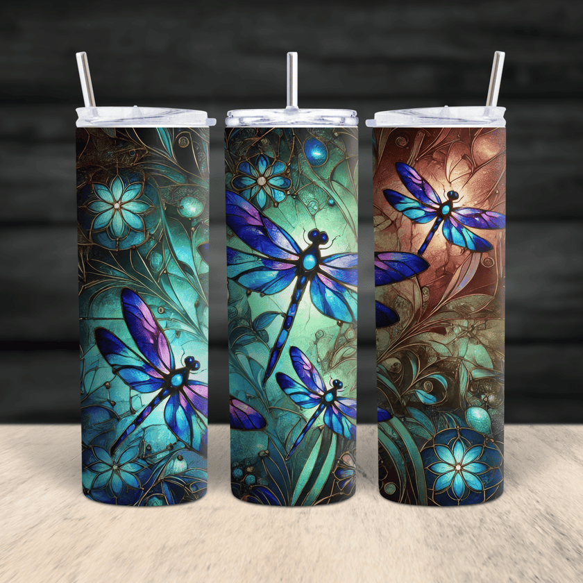 A vibrant stainless steel tumbler featuring stained-glass style dragonflies in blue, teal, and purple tones.