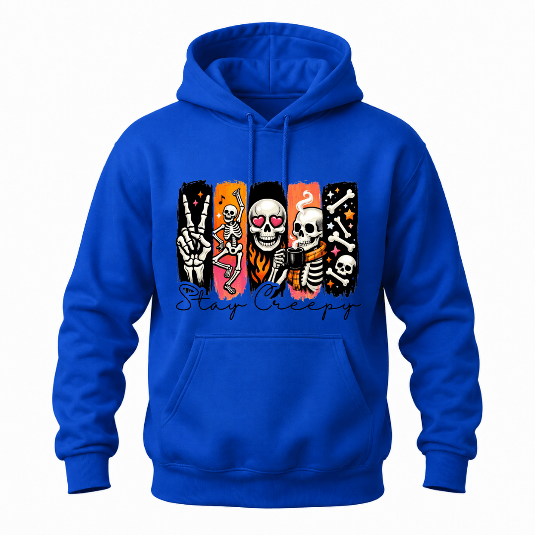 A royal blue pullover hoodie with a colorful graphic on the chest featuring cartoon skeletons in vertical panels with hearts and the text 'Stay Creepy' in script.