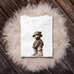 White t-shirt folded with urban teddy bear streetwear design n a fluffy white rug