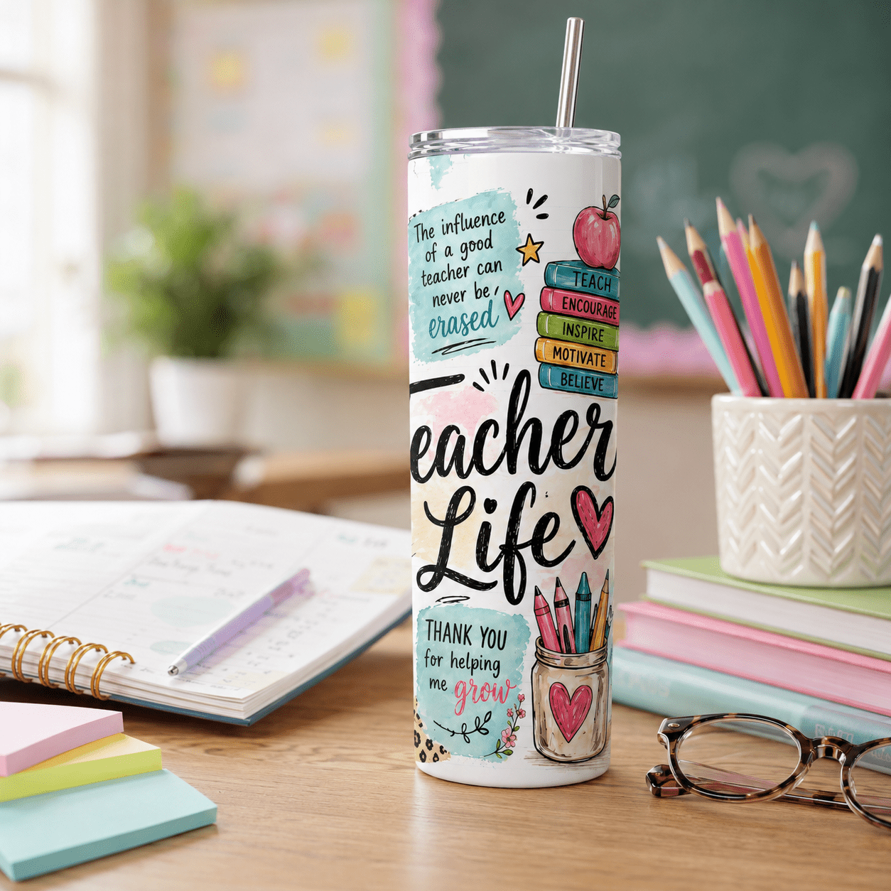 Thoughtful teacher gift tumbler with school themed artwork, inspirational quotes, colorful classroom details, lid, and straw.