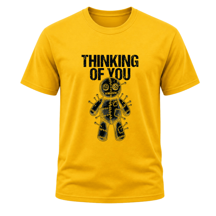 A yellow short-sleeve crewneck t-shirt featuring a black graphic of a stitched voodoo doll with pins and the text 'THINKING OF YOU' printed above it, shown against a plain white background.