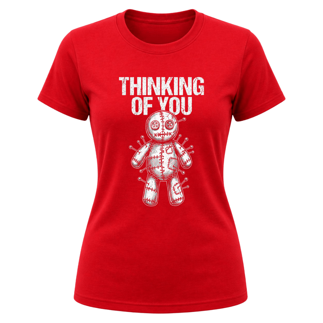 Red women’s Thinking of You graphic tee with white distressed typography and pinned voodoo doll illustration